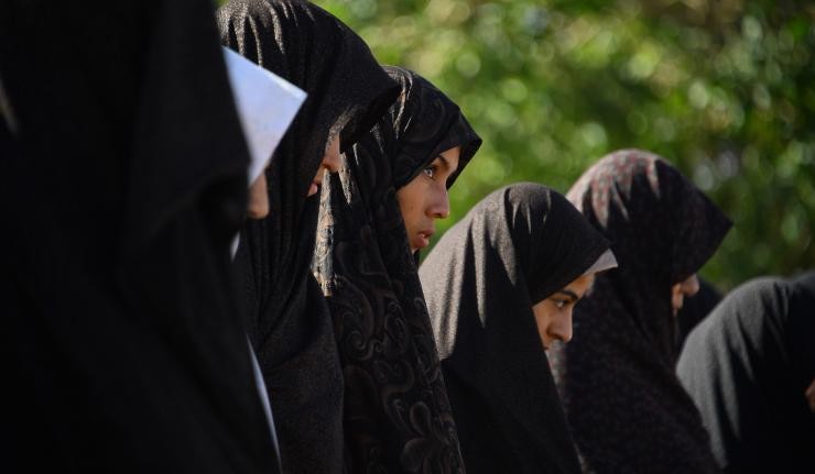 A row of Afghan women dressed in Hijabs
