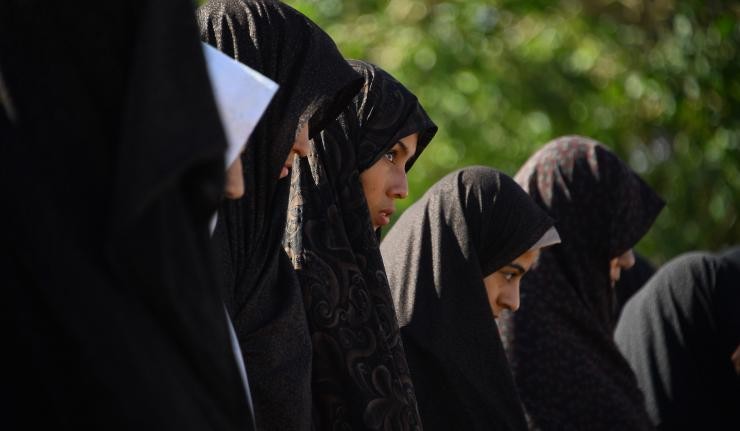 A row of Afghan women dressed in Hijabs A row of Afghan women dressed in Hijabs