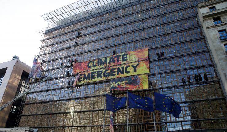 Boarded up building in the EU with a banner titled Climate Emergency
