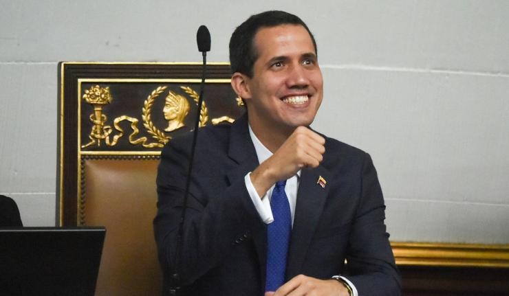 Juan Guaido againt a podium Juan Guaido againt a podium