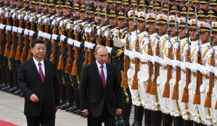 Xi Jinping and Putin in foreground Chinese soldiers in background Xi Jinping and Putin in foreground Chinese soldiers in background
