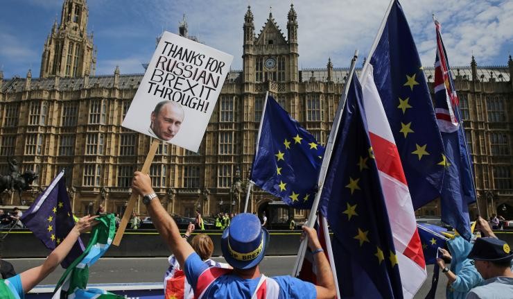 Protestors outside Palace of Westminster carrying EU, English and UK flags Protestors outside Palace of Westminster carrying EU, English and UK flags