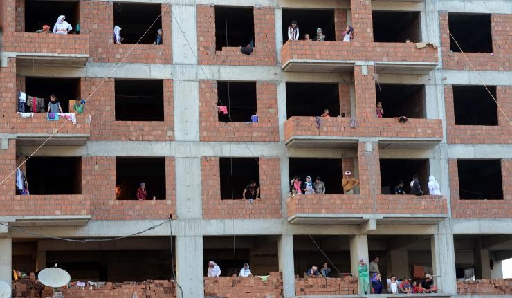 People living in a dilapidated red-brick building in Iraq People living in a dilapidated red-brick building in Iraq