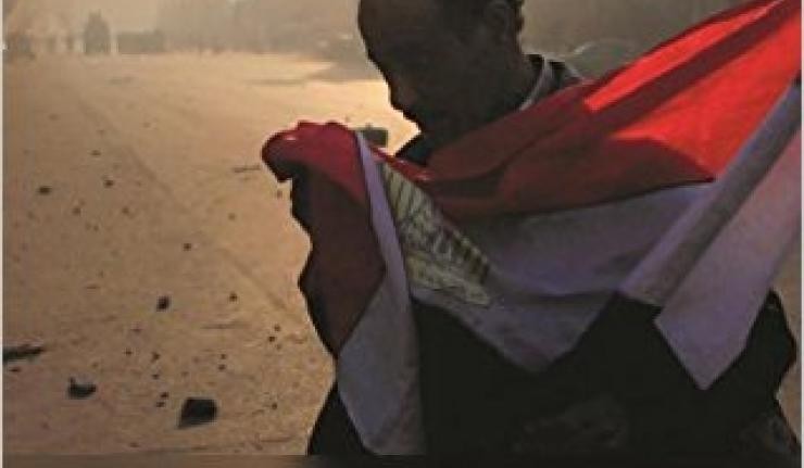 Protestor draping the flag of Egypt around himself