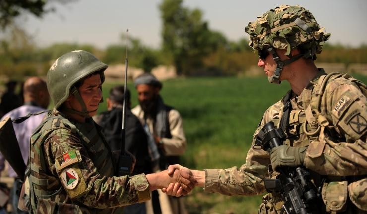 Troops from U.S. and Afghan armies shaking hands Troops from U.S. and Afghan armies shaking hands