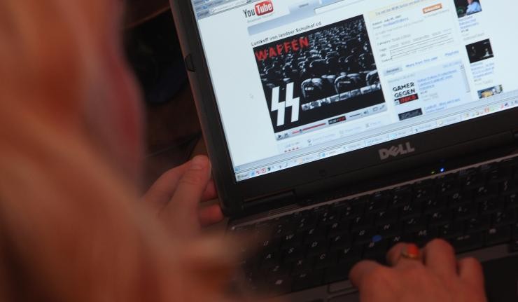 A Person watching Youtube videos of Waffen, the military arm of the German Nazi Party A Person watching Youtube videos of Waffen, the military arm of the German Nazi Party