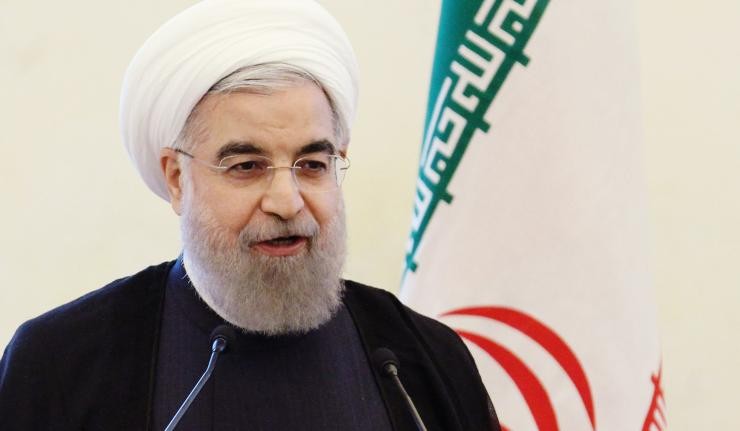 President Hassan Rouhani with an Iranian flag behind him