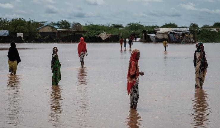 People wading through floods in rural Kenya