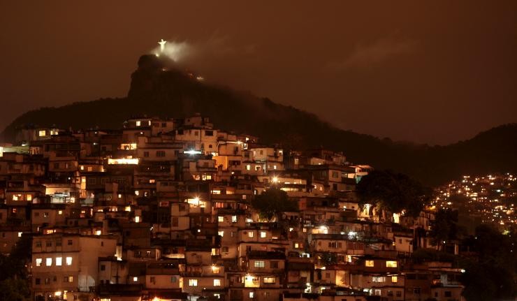 Nighttime image of the Bairros of Rio with Christ the Redeemer lit and visible atop the hill