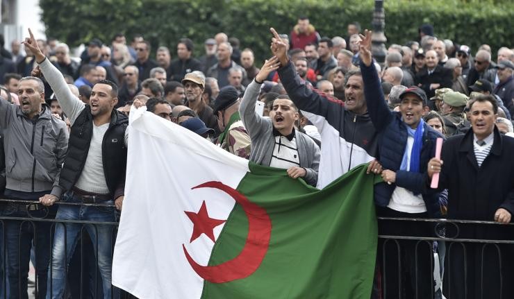 Algerian protestors holding the Algerian Flag Algerian protestors holding the Algerian Flag