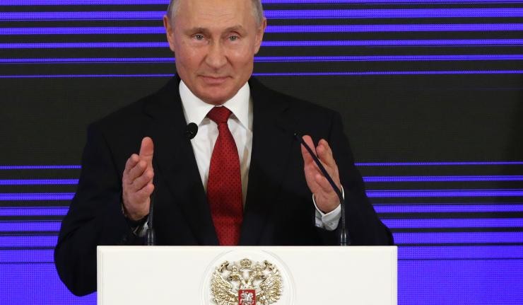 Vladimir Putin at a speaker's podium