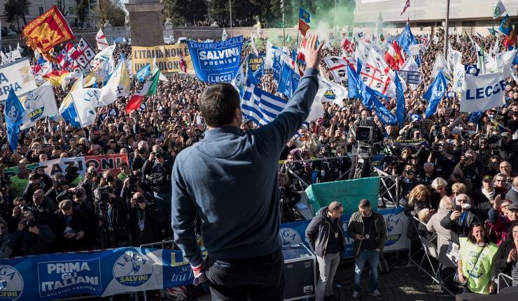 Matteo Salvini waving to an audience at a political rally