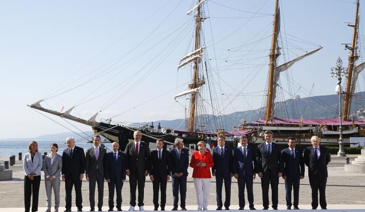 Heads of states of all EU governements standing in a row with a ship in the background Heads of states of all EU governements standing in a row with a ship in the background