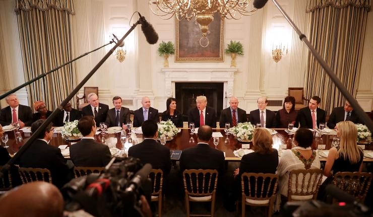 Donald Trump and his advisors seated around a table discussing the end to the JCPOA nuclear agreement with Iran