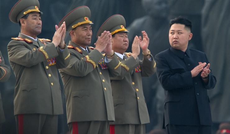 Kim Jong Un applauding with three army officers also clapping