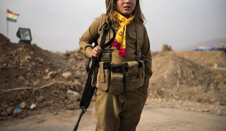 Child soldier walking with a rifle