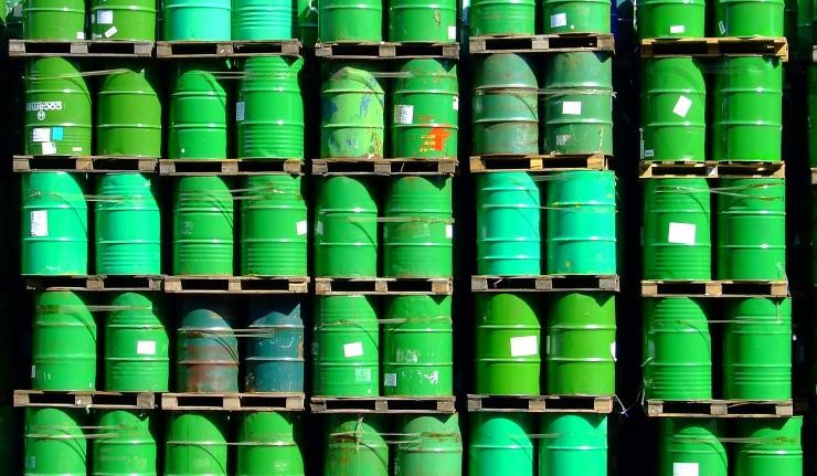 Green barrels of oil stacked on top of each other Green barrels of oil stacked on top of each other