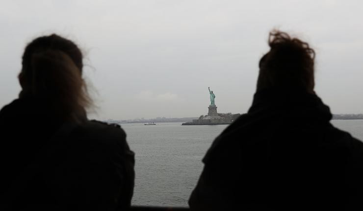 Two citizens gazing at the Statue of Liberty from Liberty Park