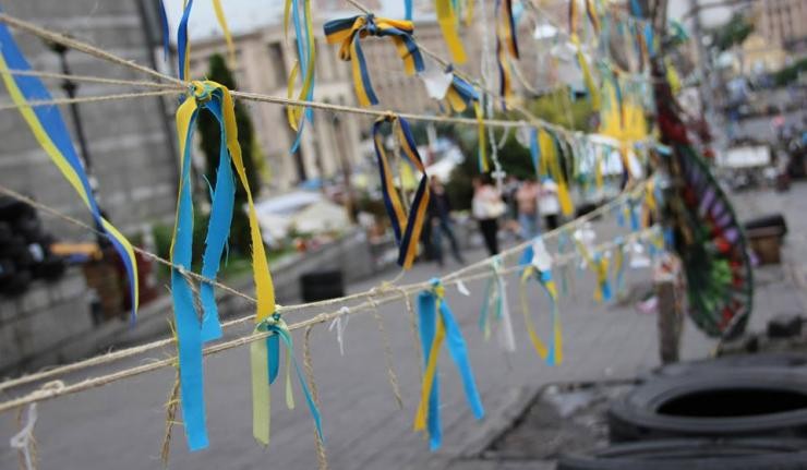 Strings tied between poles in Ukraine with blue and yellow paper festoons tied to the strings