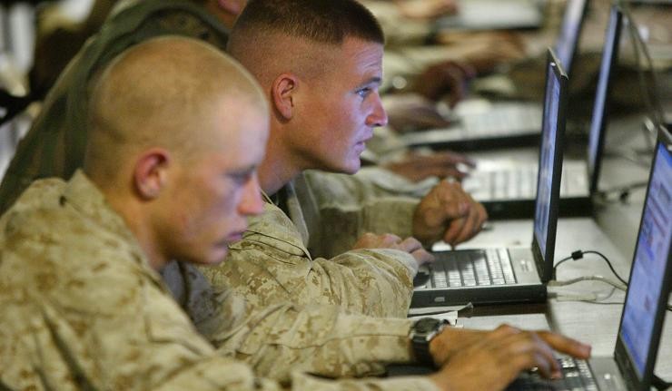 Officers of the US Army carrying out cyber surveillance on their laptops