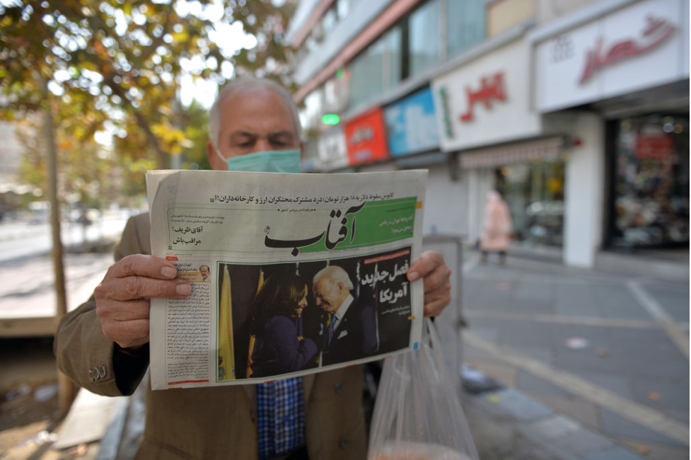 Man reading newspaper in Tehran