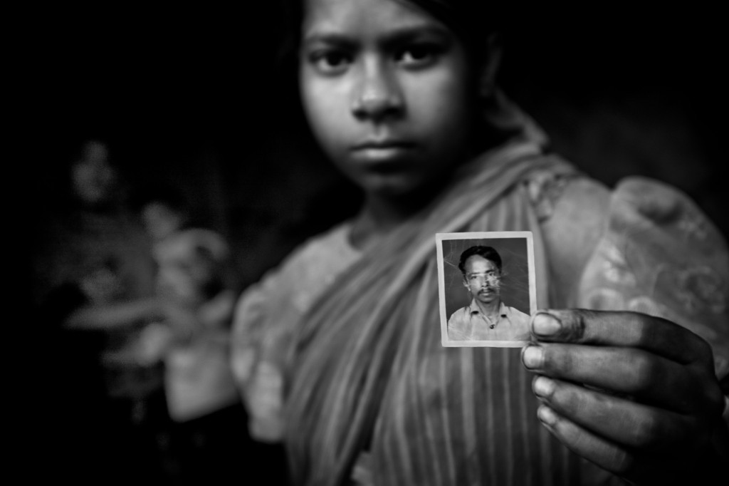 Anwara Khatun, an orphan, shows a photograph of her stepfather. He tried to rape her three times. Anwara’s mother saved her each time. Eventually her stepfather took revenge and killed her mother. Although a case has been filed against him for the murder of her mother, he has still not been arrested.
