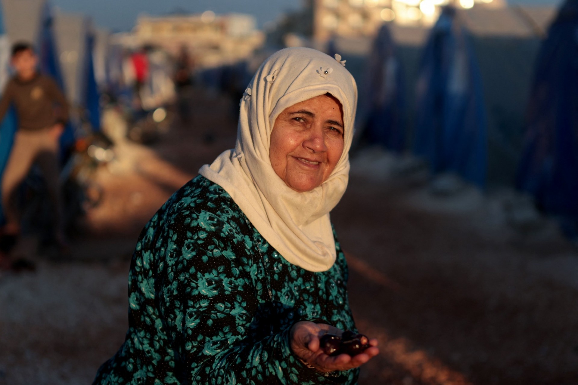 Female Syrian refugee smiles at camera