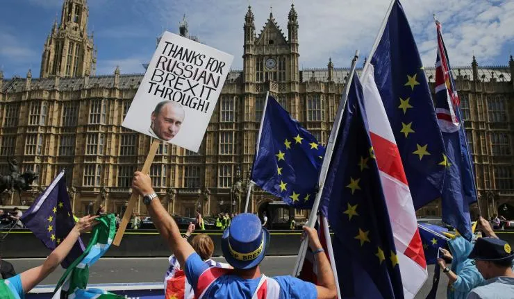 Protestors outside Palace of Westminster carrying EU, English and UK flags