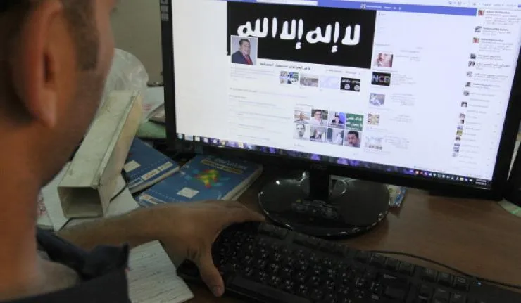 Man viewing ISIS' facebook page on his desktop monitor