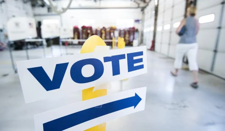 A polling station in Europe with a signboard with the word 'Vote'