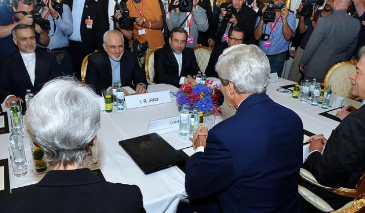 Back view of John Kerry and deputies sat across the table from Iranian Foreign Minister Mohammad Javad Zarif during the Nuclear deal talks