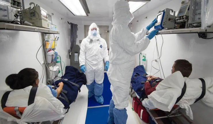 A medical ward or emergency room with two patients having their vital signs monitored using a scope