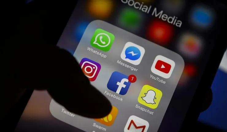 An iPhone screen with several social media apps