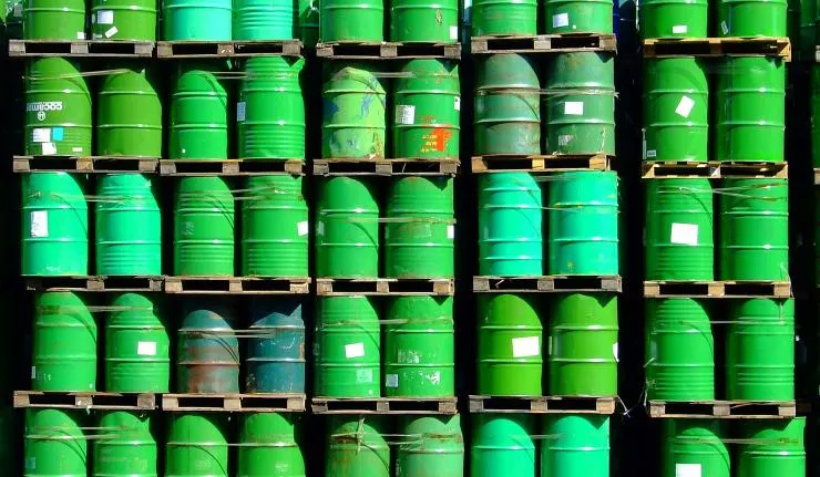 Green barrels of oil stacked on top of each other