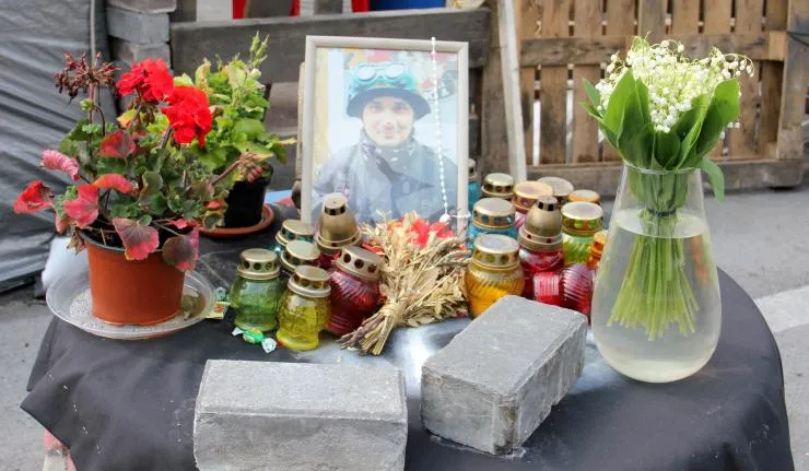 Tribute to a killed protestor in the Urkraine's Euromaidan revolution with Candles and Flowers placed against his framed photograph