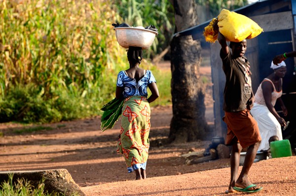 Woman and child carrying loads on their heads