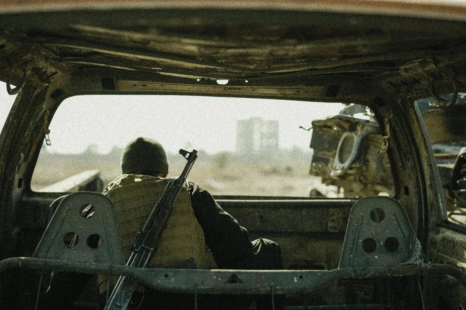 Soldier observing from abandoned vehicle. Image by Amorie Sam.