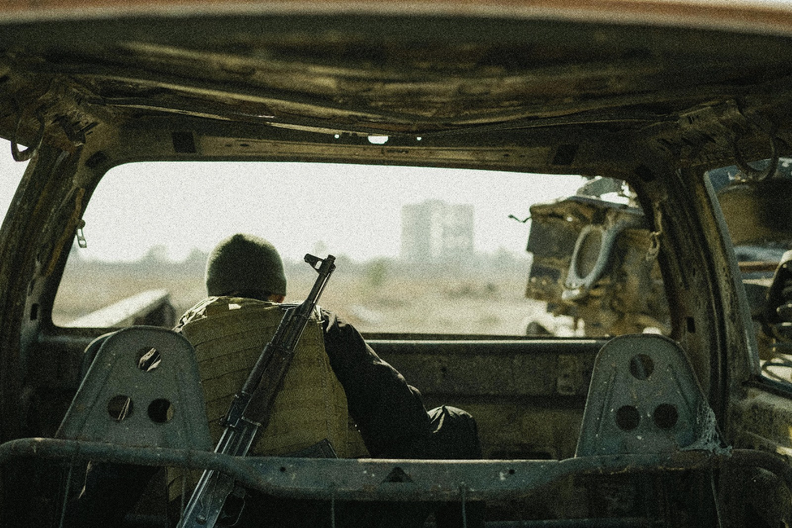 Soldier observing from abandoned vehicle. Image by Amorie Sam.